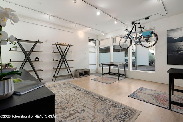 interior space with track lighting and wood finished floors