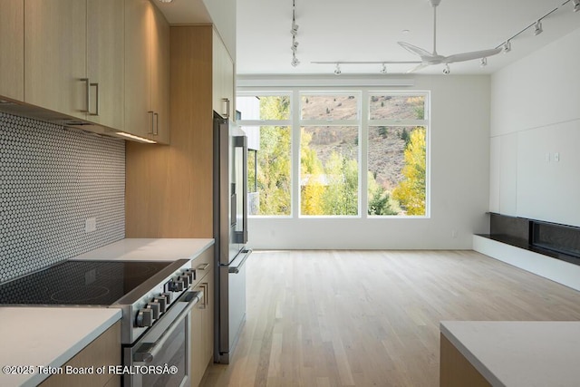 kitchen featuring stainless steel appliances, light countertops, and a healthy amount of sunlight