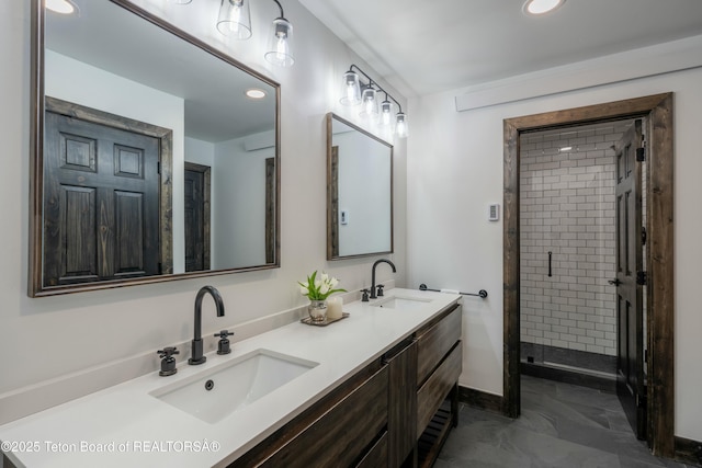 bathroom featuring a sink, a shower stall, baseboards, and double vanity