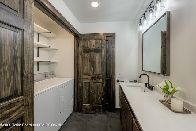 bathroom featuring vanity and washer and dryer