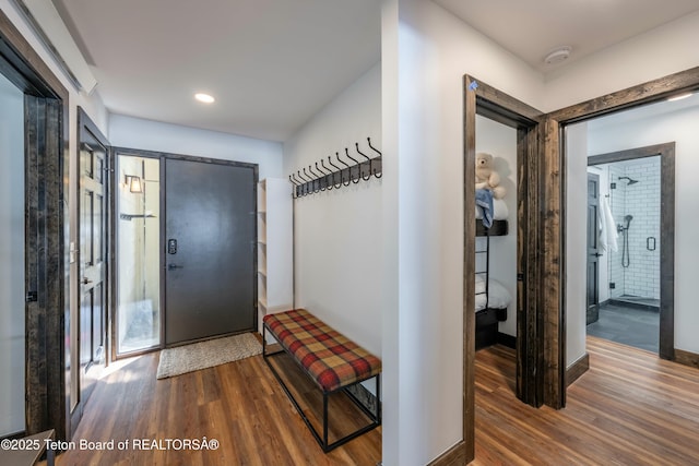 foyer with baseboards, wood finished floors, and recessed lighting