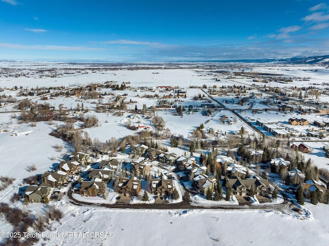 snowy aerial view with a residential view