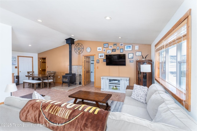 living room with lofted ceiling, a wood stove, and recessed lighting