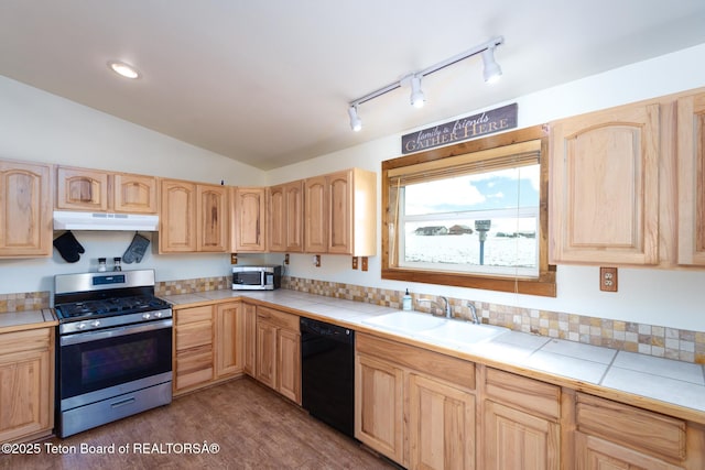 kitchen featuring appliances with stainless steel finishes, light brown cabinets, and under cabinet range hood