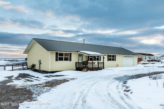 view of front facade featuring an attached garage and metal roof