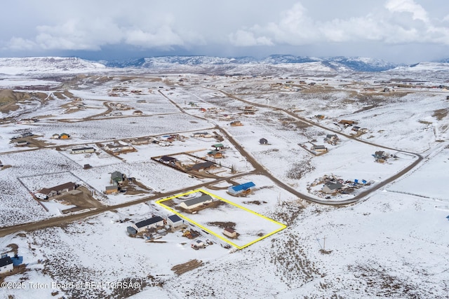 snowy aerial view with a mountain view