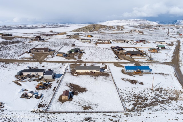 snowy aerial view featuring a mountain view