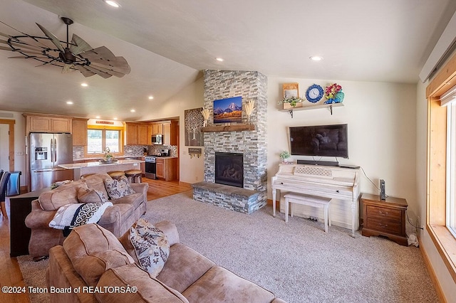 living area featuring recessed lighting, light colored carpet, a fireplace, and vaulted ceiling