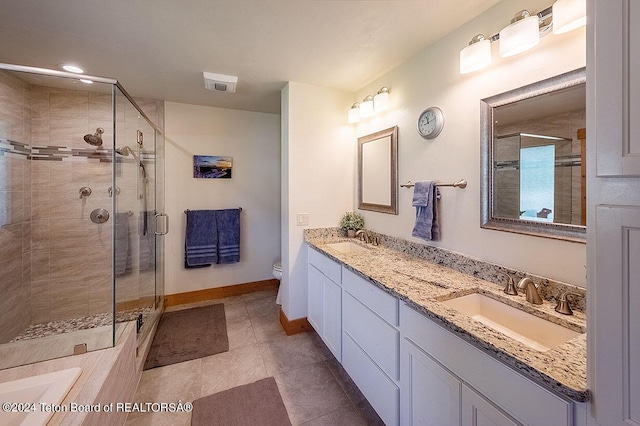 bathroom with a sink, toilet, and a stall shower