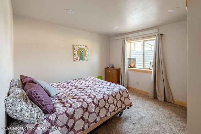 bedroom featuring carpet flooring and baseboards