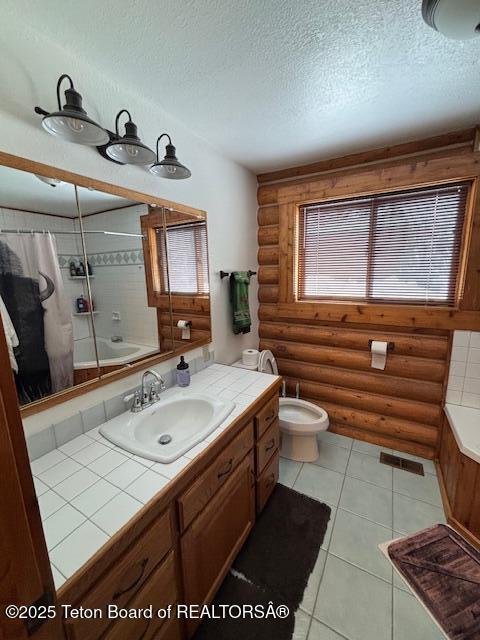 bathroom featuring a textured ceiling, toilet, vanity, visible vents, and log walls