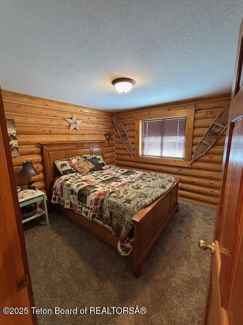 bedroom featuring a textured ceiling and carpet floors