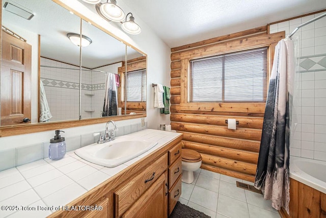 bathroom with visible vents, a textured ceiling, and a healthy amount of sunlight