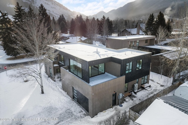 snowy aerial view with a mountain view