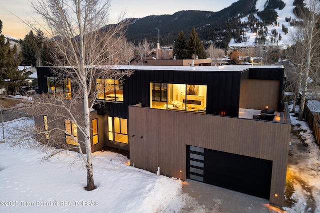 modern home featuring a mountain view and a garage