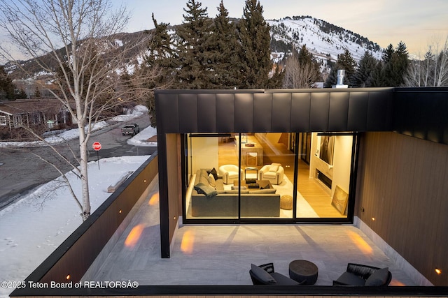 exterior space featuring a mountain view and a balcony