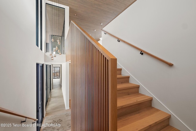 staircase featuring a towering ceiling