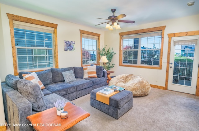 living room featuring carpet flooring and ceiling fan