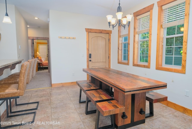 dining area with recessed lighting, a notable chandelier, baseboards, and light tile patterned floors