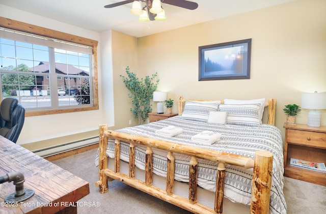 carpeted bedroom featuring ceiling fan and baseboard heating