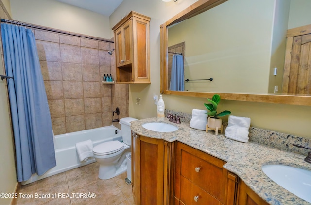 bathroom featuring double vanity, shower / tub combo, a sink, and toilet