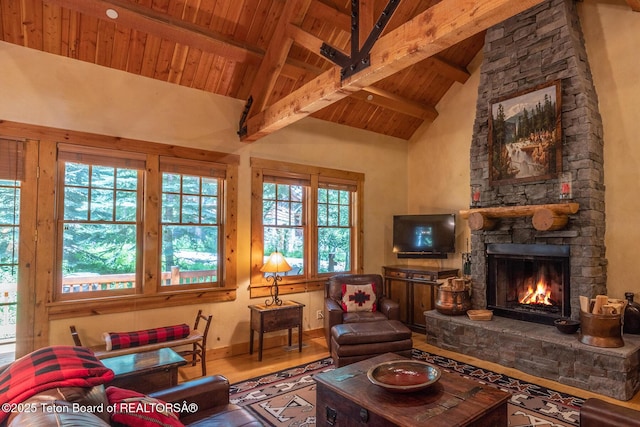 interior space featuring wooden ceiling, wood finished floors, beamed ceiling, a fireplace, and high vaulted ceiling