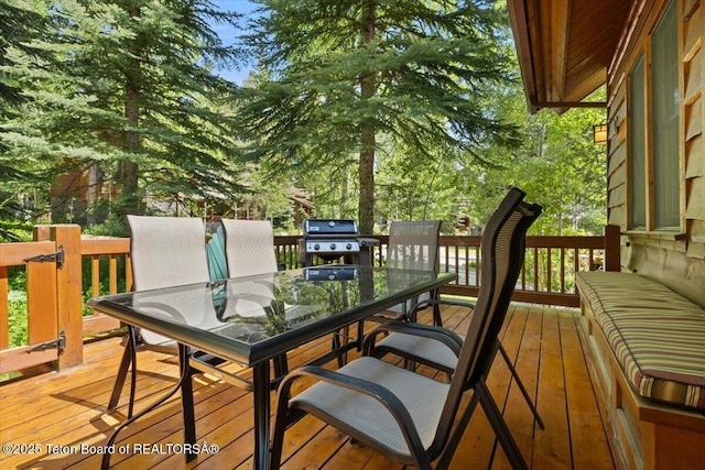 3102 W Arrowhead Rd, Teton Village, WY 83025 - wooden terrace with outdoor dining area and a grill