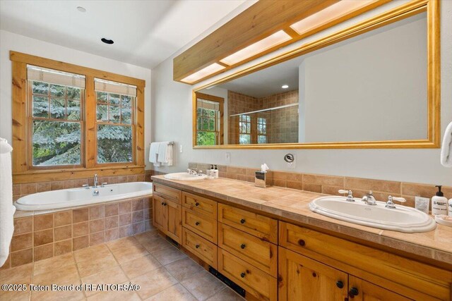 3102 W Arrowhead Rd, Teton Village, WY 83025 - bathroom with double vanity, tile patterned floors, a bath, and a shower stall