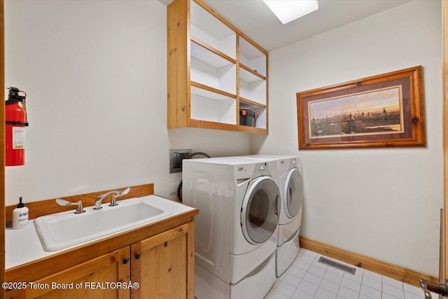 3102 W Arrowhead Rd, Teton Village, WY 83025 - laundry area with washing machine and dryer, cabinet space, and light tile patterned floors