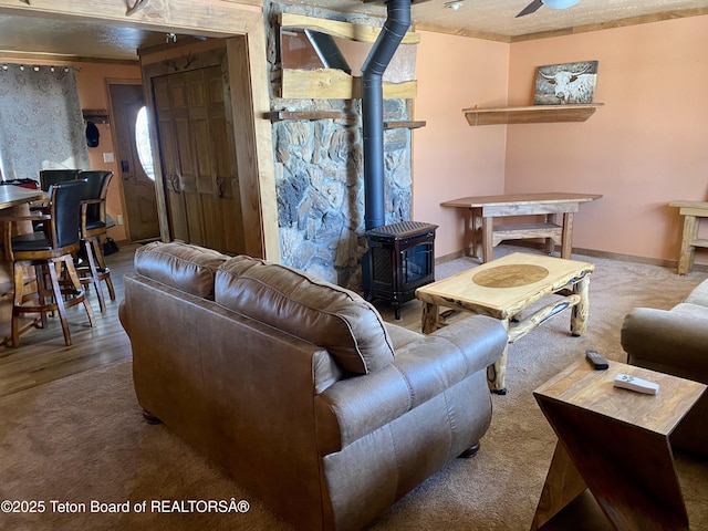 living area with a wood stove and baseboards