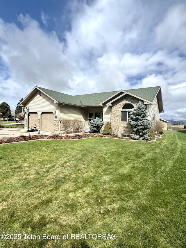 30 Miles Mdw, Afton, WY 83110 - single story home featuring a garage, roof with shingles, and a front yard