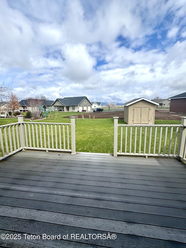 30 Miles Mdw, Afton, WY 83110 - wooden deck with an outdoor structure, a storage unit, a playground, a yard, and a residential view