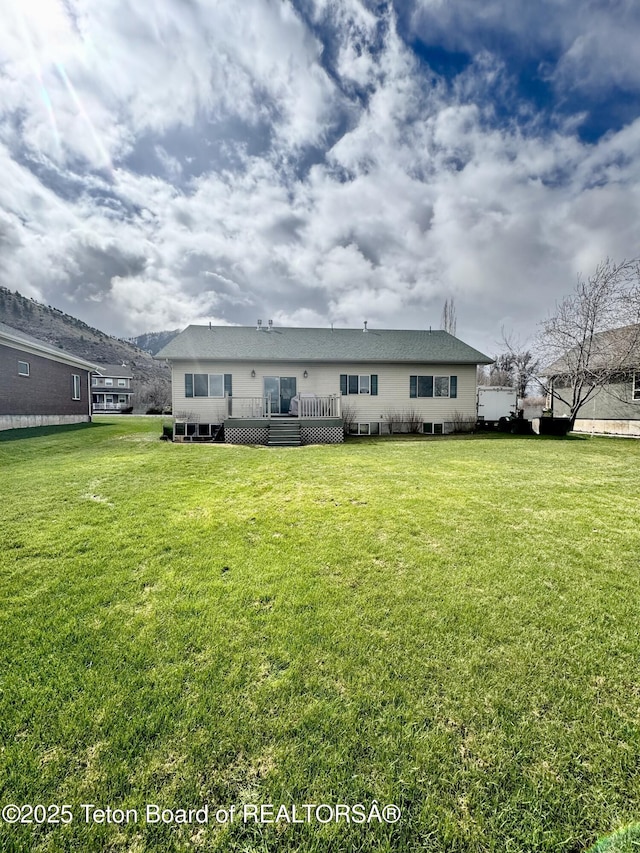 30 Miles Mdw, Afton, WY 83110 - back of property with a wooden deck and a yard