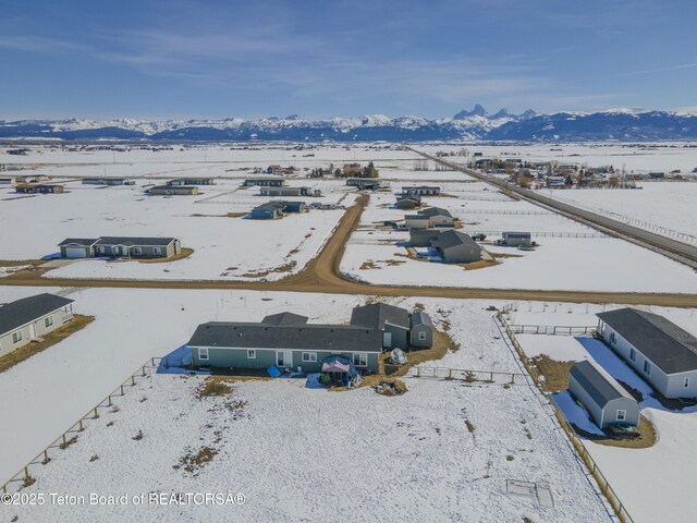 snowy aerial view featuring a mountain view