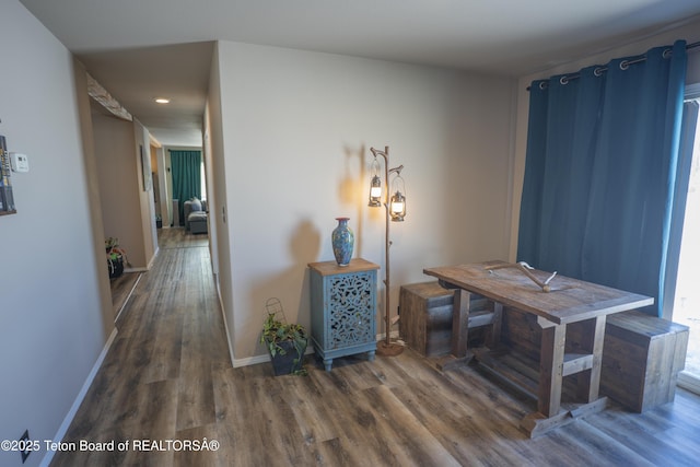 dining space with wood finished floors and baseboards