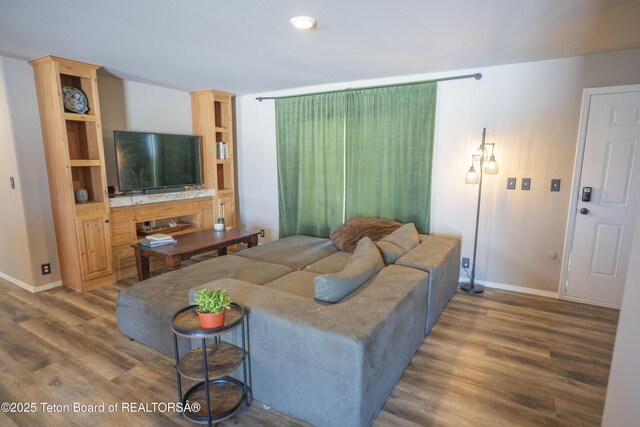 living room featuring baseboards and wood finished floors