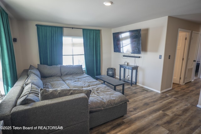 living room with baseboards and dark wood-style floors