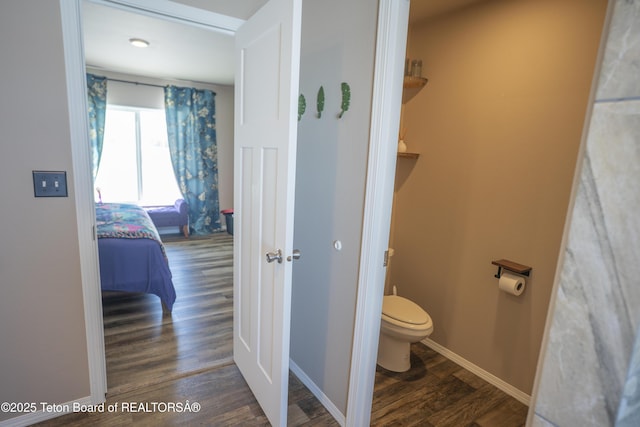 bathroom featuring toilet, wood finished floors, and baseboards