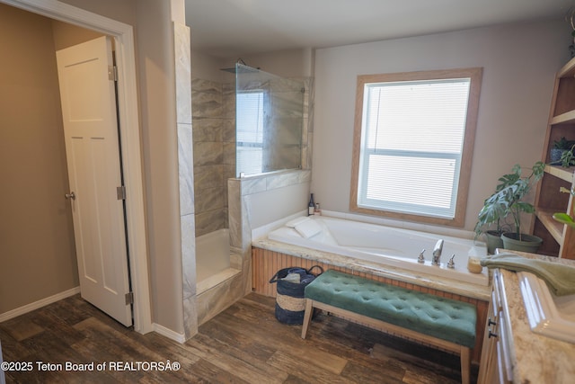 full bathroom with vanity, wood finished floors, baseboards, tiled shower, and a garden tub