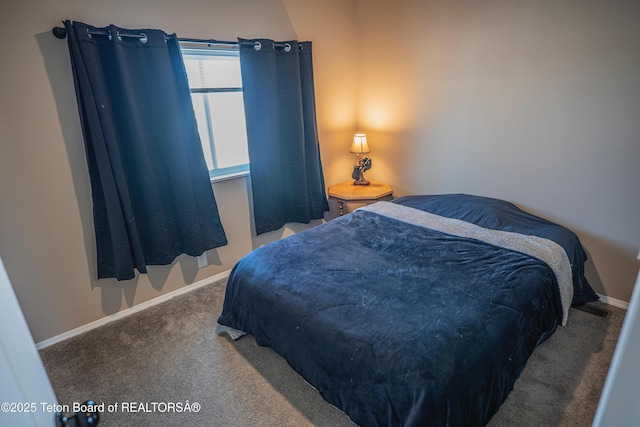 carpeted bedroom featuring baseboards