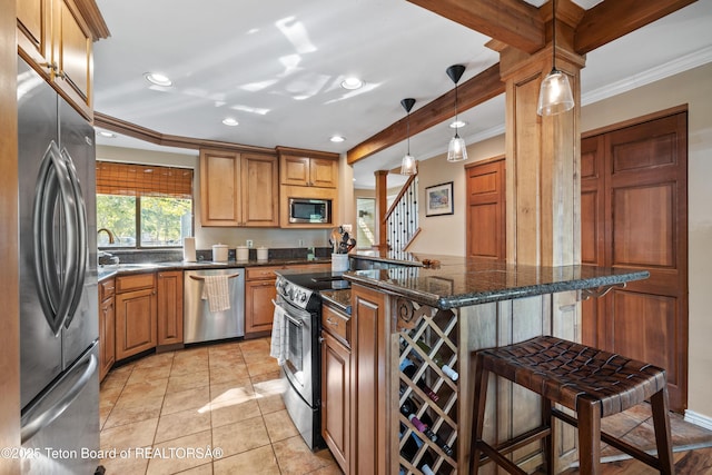 kitchen featuring a breakfast bar, light tile patterned floors, stainless steel appliances, and ornamental molding