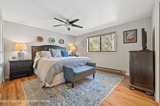 bedroom with baseboards, a ceiling fan, a baseboard heating unit, and light wood-style floors