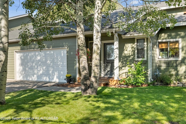 view of front facade with a front yard and a garage