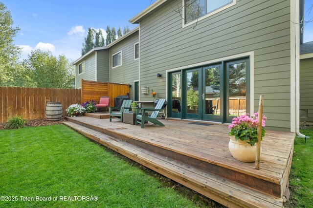 deck featuring fence and a lawn