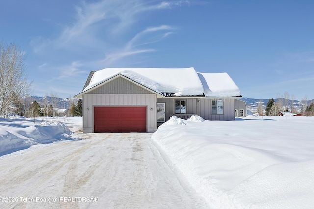 view of front of home featuring a mountain view, a garage, and board and batten siding