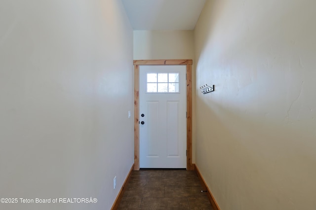 doorway featuring baseboards