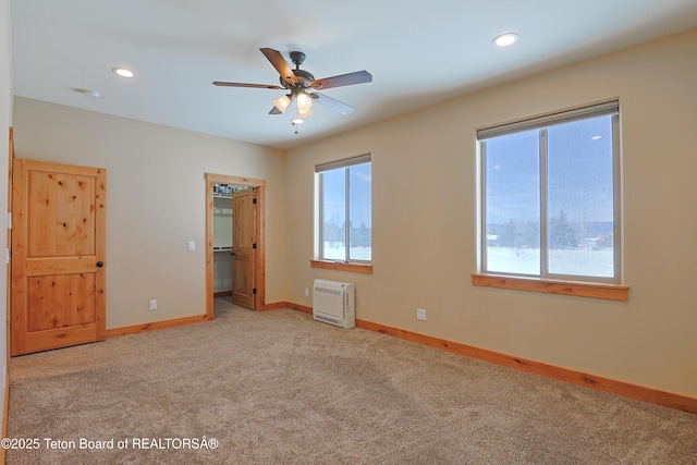 unfurnished bedroom featuring baseboards, carpet floors, recessed lighting, a spacious closet, and a closet