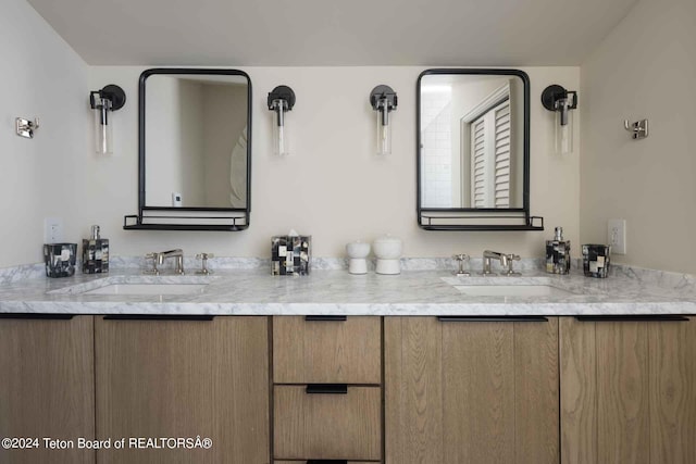 full bath with a sink and double vanity