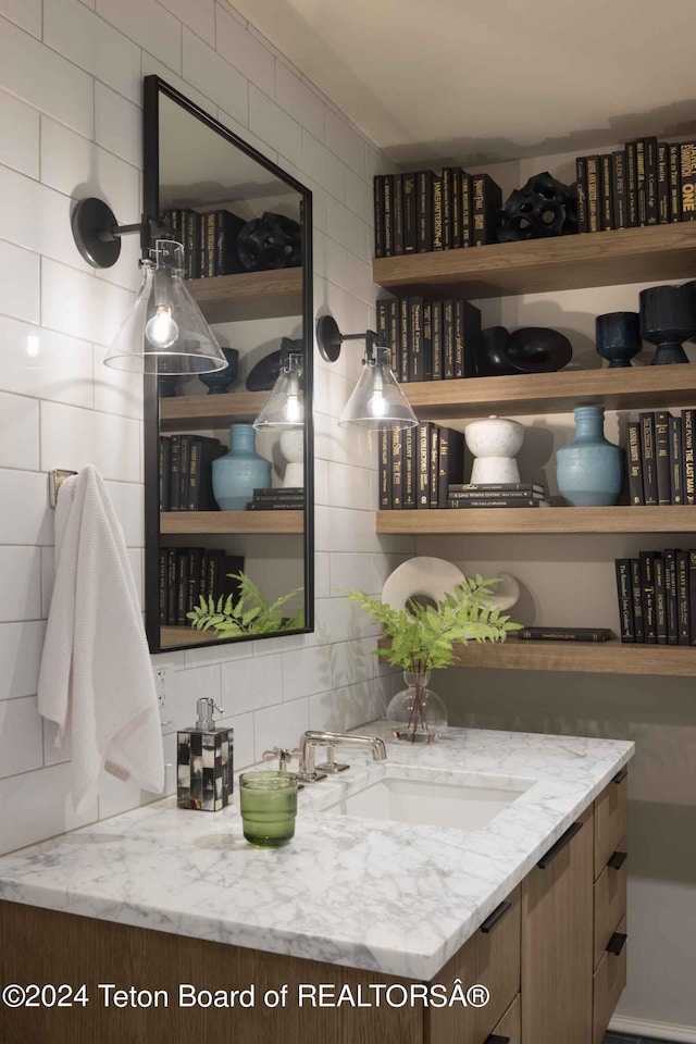 interior space with decorative backsplash, tile walls, and a sink