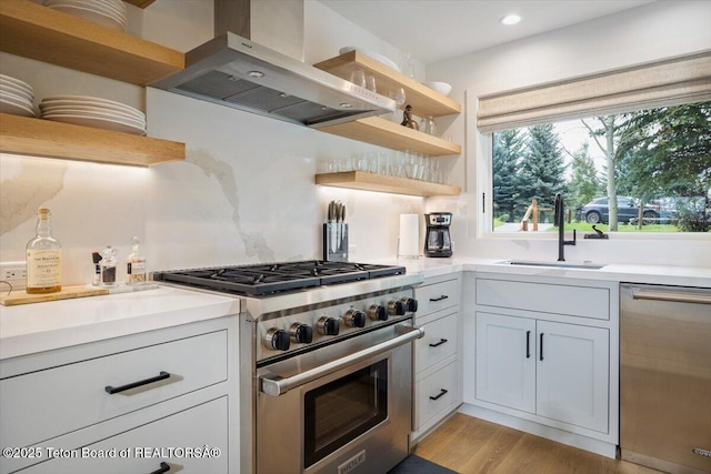 kitchen with range hood, open shelves, a sink, stainless steel appliances, and light countertops